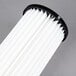 A close-up of a white and black HEPA filter for Hoover Hush 15" Upright vacuums.