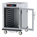 A large white Metro holding cabinet with a clear door open.