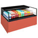 A Structural Concepts Reveal refrigerated self-service air curtain merchandiser on a counter with bottles of soda and soft drinks.