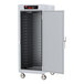 A white metal Metro C5 holding cabinet with wheels.