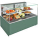 A Structural Concepts refrigerated bakery display case with food on shelves.