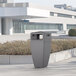 A Mayne graphite grey rectangular decorative waste bin on a sidewalk.
