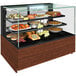 A Structural Concepts refrigerated bakery display case with food on shelves.