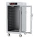 A white Metro holding cabinet with a clear door and shelves inside.