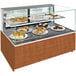 A Structural Concepts non-refrigerated bakery display case with shelves holding a variety of desserts.