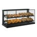 A Structural Concepts countertop bakery display case filled with baked goods.