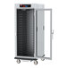 A large metal Metro C5 holding cabinet with a clear door and shelves.