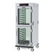 A Metro C5 low wattage holding cabinet with clear Dutch doors and chrome slides.