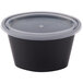 A black Pactiv oval plastic souffle container with a clear lid.