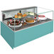 A Structural Concepts refrigerated bakery display case on a counter with cakes, cupcakes, and desserts inside.