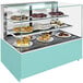 A Structural Concepts non-refrigerated bakery display case with cakes and pastries on two shelves.