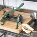 A Choice Prep potato wedge cutter on a cutting board with sliced potatoes.