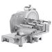 A silver Sirman manual meat slicer with a round metal surface.