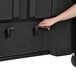 A hand pushing a black IRP Arctic cooler on casters.