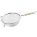 A Vollrath stainless steel strainer with a wood handle.