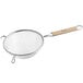 A Vollrath stainless steel mesh strainer with a wooden handle.