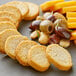 A plate of food with Meliora Traditional Mini Bruschette Toast, cheese, and olives.