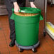 a person holding a green container full of pasta