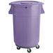 A purple plastic trash can on wheels.