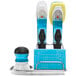 An OXO Good Grips sink organizer holding a blue and white dish brush.