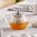 a glass teapot with a clear glass lid and a clear liquid inside