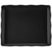 A black rectangular tray with a scalloped edge.