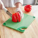 a person cutting a pepper with a knife