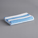 An Oxford blue and white striped pool towel.