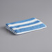 An Oxford blue and white striped pool towel.