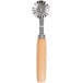 A Ateco stainless steel pastry cutter with a fluted circular wheel and wood handle.