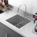 A close-up of a Regency stainless steel fabricated weld-in undermount sink bowl.