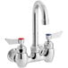 A silver Waterloo wall mount faucet with red knobs.