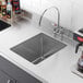 A stainless steel Regency fabricated undermount sink bowl with a hole in it.