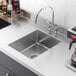 A close-up of a Regency stainless steel undermount sink bowl.