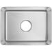 A silver fabricated stainless steel undermount sink bowl with a hole in the center.