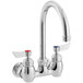 A silver Waterloo wall mount faucet with red handles.