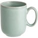A close-up of a Harbor Blue matte porcelain mug with a handle.