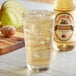 A glass of ice with a bottle of Reading Soda Works Honey Pear.