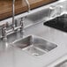 A close-up of a Vollrath stainless steel sink.