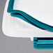 A white OXO rectangular polypropylene container with a blue lid.