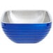 A cobalt blue Vollrath metal bowl with a stainless steel handle.