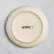 An Acopa fog white matte porcelain saucer with a brown rim.