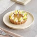 A lemon tart on an Acopa Pangea fog white porcelain plate.