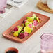 A white rectangular porcelain platter with a plate of vegetables on a table.