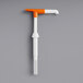 A white cylindrical Choice Maxi condiment pump with an orange and white tube.