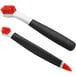 An OXO Good Grips brush set with black and orange bristles.