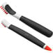 An OXO Good Grips janitorial brush set with orange handles and black bristles.