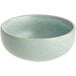An Acopa Harbor Blue matte porcelain ramekin on a table in a salad bar.
