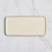 A rectangular white porcelain platter with a white border.
