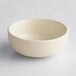 An Acopa Pangea white matte porcelain ramekin on a white surface.